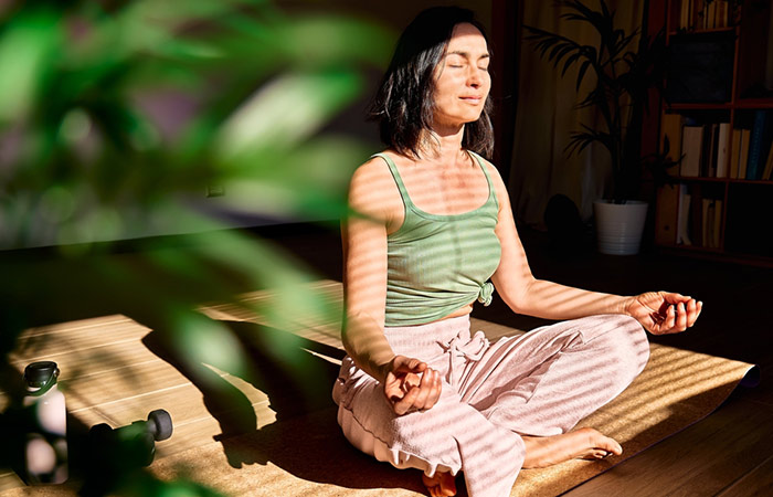Woman destressing with yoga and meditation