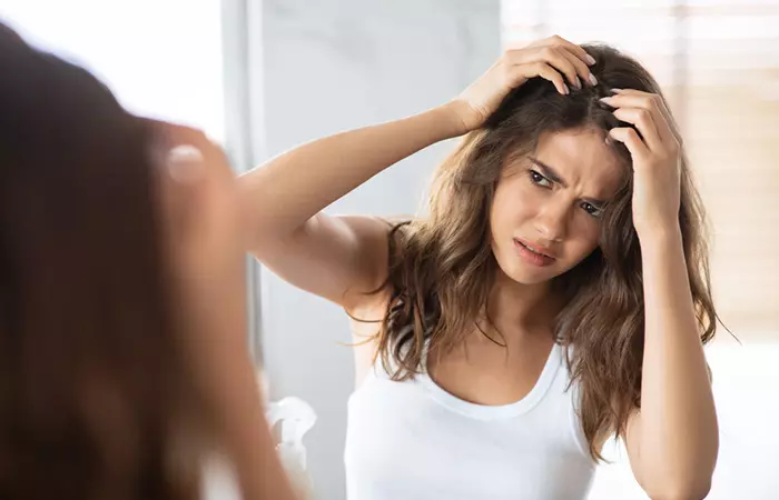 Woman with itchy scalp due to dandruff may benefit from tea tree oil