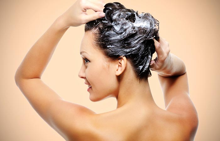 Woman applying horsetail shampoo on hair