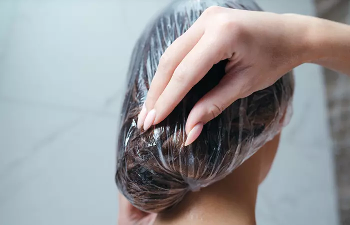 Woman wearing shower cap to get rid of lice