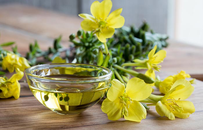 Evening primrose flowers and oil in a glass bowl