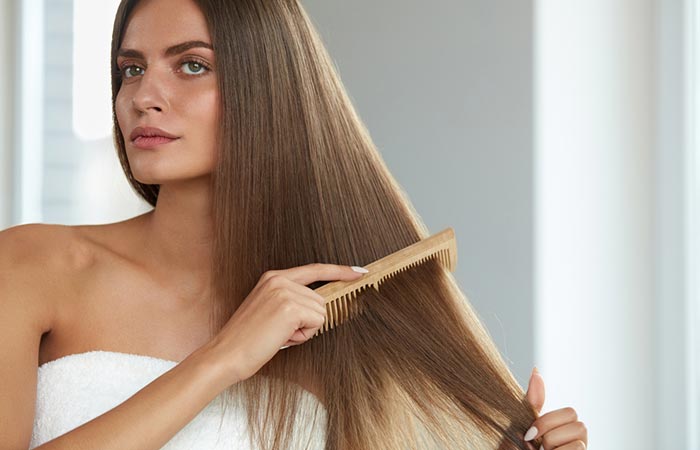 Woman brushing her manageable straight hair
