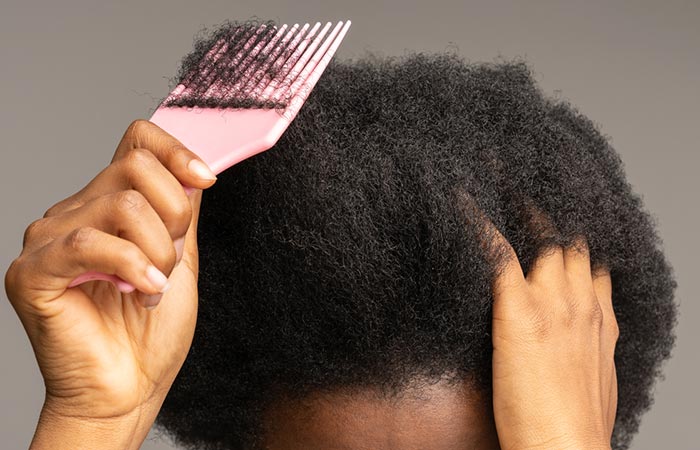 Woman experiencing breakage due to hair grease