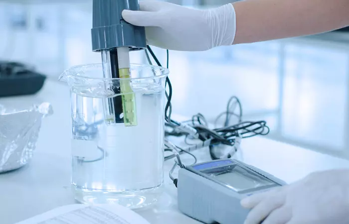 Woman checking quality of distilled water for hair