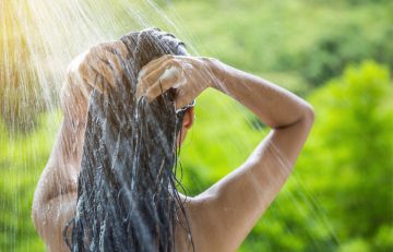 Woman washing hair 24 to 48 hours before applying hair dye
