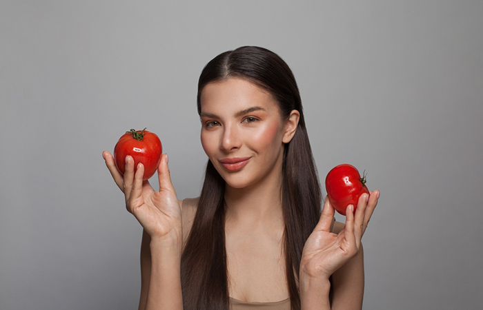 Woman with healthy hair holding tomatoes