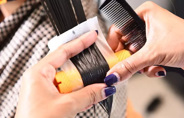 Woman undergoing hair perming