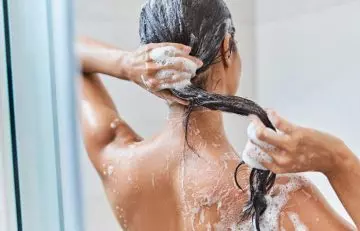 Woman washing her staright hair with a gentle shampoo