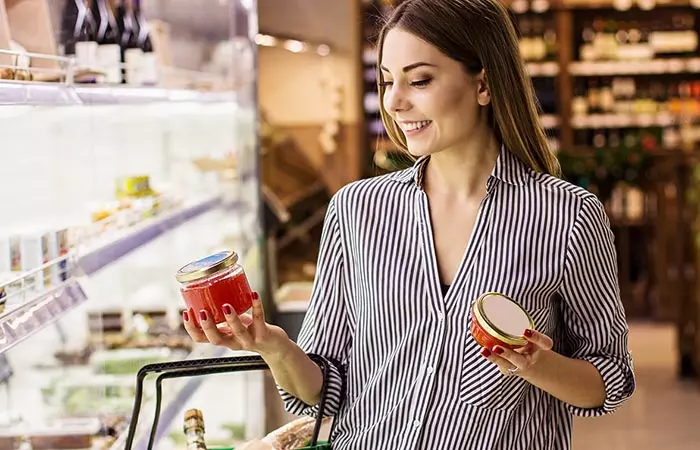 Woman reading instructions on facial wax jar