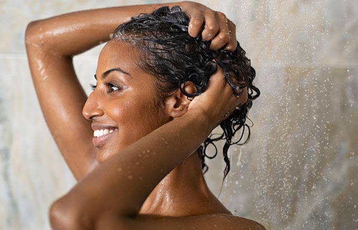 Woman applying clarifying shampoo to remove hair grease