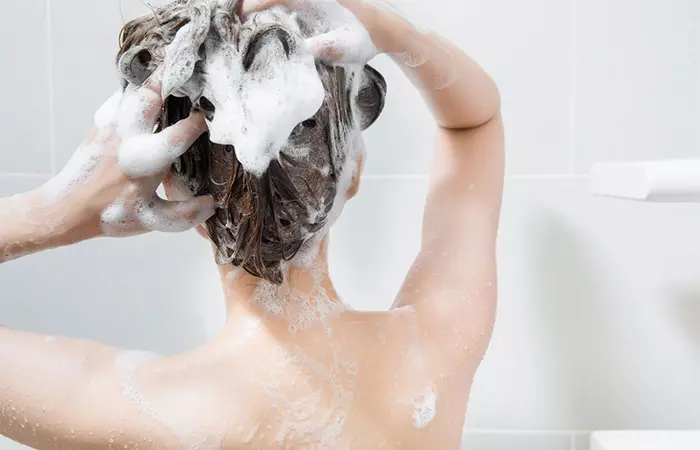 Woman washing her hair with distilled water 