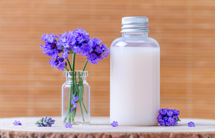Jars of milk and lavender essential oil for glowing skin