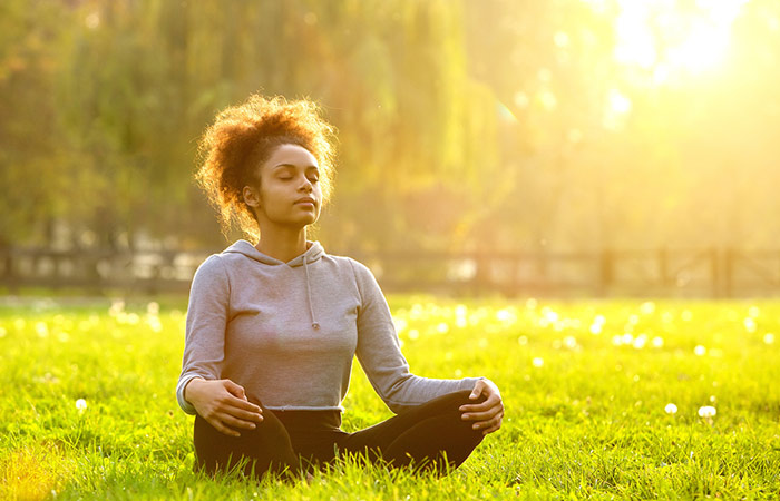 Woman practicing meditation in a park