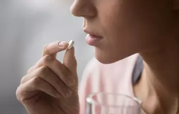 Woman taking oral medicines for seborrheic dermatitis