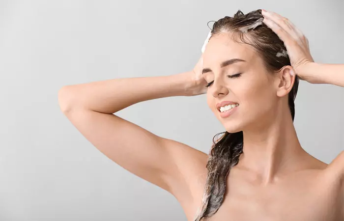 Woman washing hair with clarifying shampoo