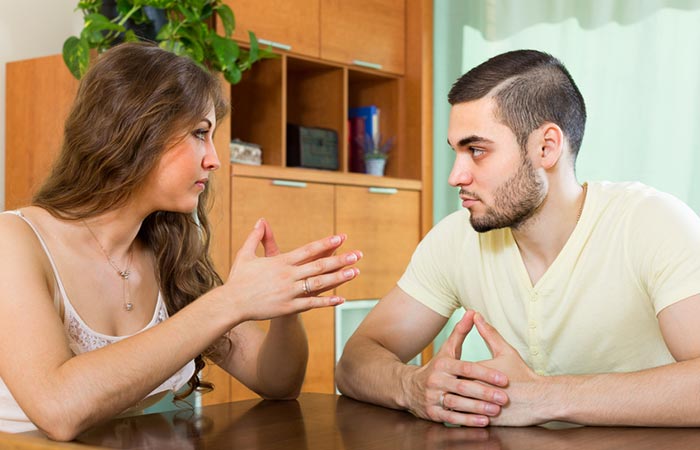 Couple sitting face-to-face and setting ground rules in order to take a break