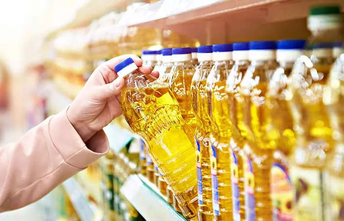 Woman picking sunflower oil from a shelf