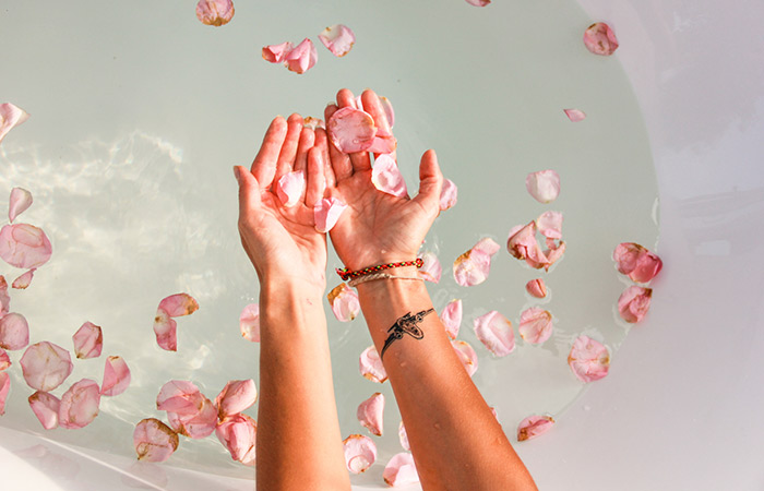 Woman holding rose petals in her hand