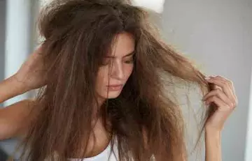 Woman holding her dry hair