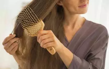 Woman combing her healthy hair