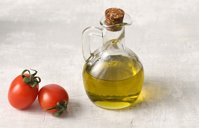 Tomatoes and a jar of olive oil