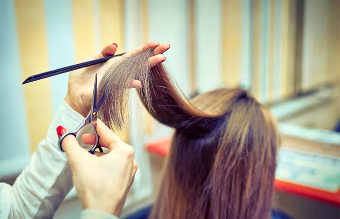 Close-up of a hairdresser trimming her customer's hair