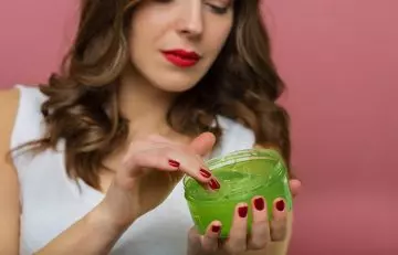 Woman using aloe vera gel on her hair