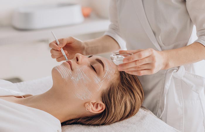 Woman getting vitamin E face mask at salon