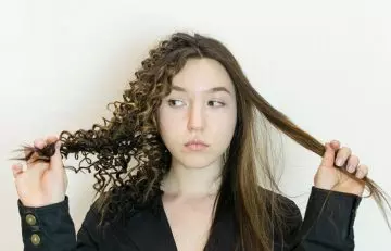 Woman Showing the difference between relaxed and curly hair