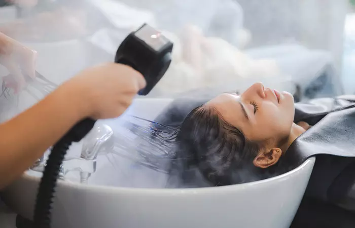 Woman getting hair spa treatment to reduce hair dye damage