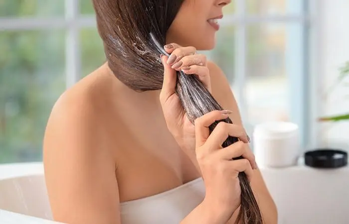 Back view of woman co-washing her hair