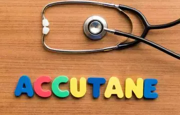 Stethoscope and accutane spelled with colorful letters on the table