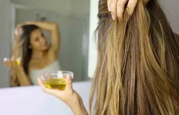 Woman applying nourishing hair oil