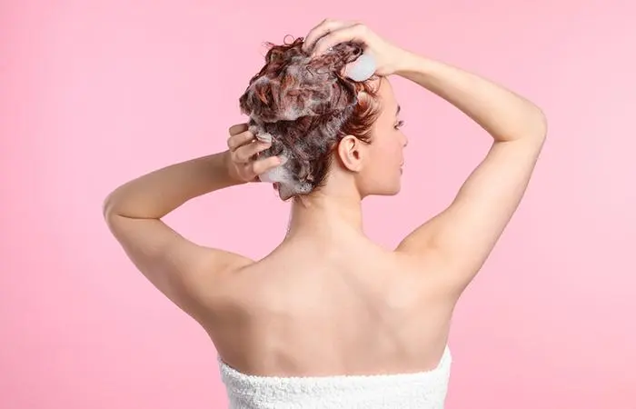 A woman shampooing her hair