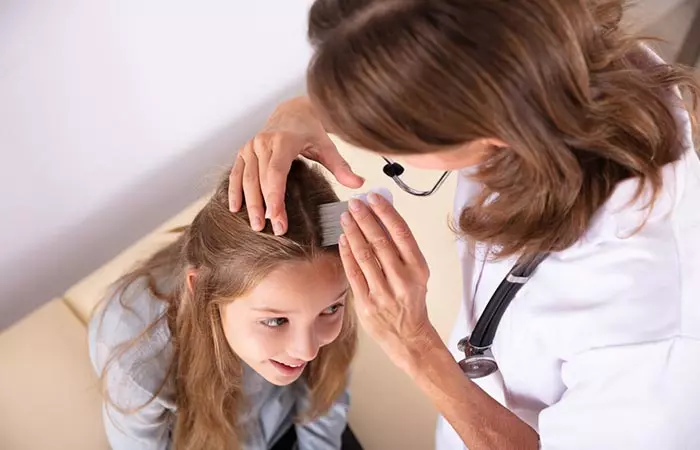 A woman checking for head lice