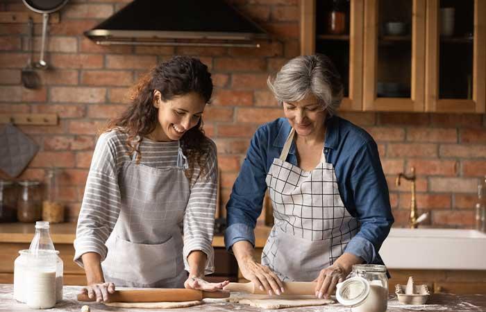 Daughter and mother cooking.