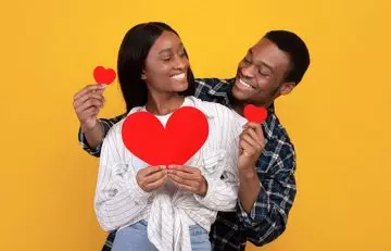 Couple in love holding paper hearts