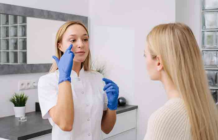 Dermatologist explaining skin tightening treatments to a client