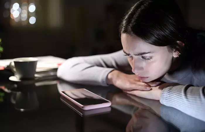 Sad woman waiting for a text from her boyfriend