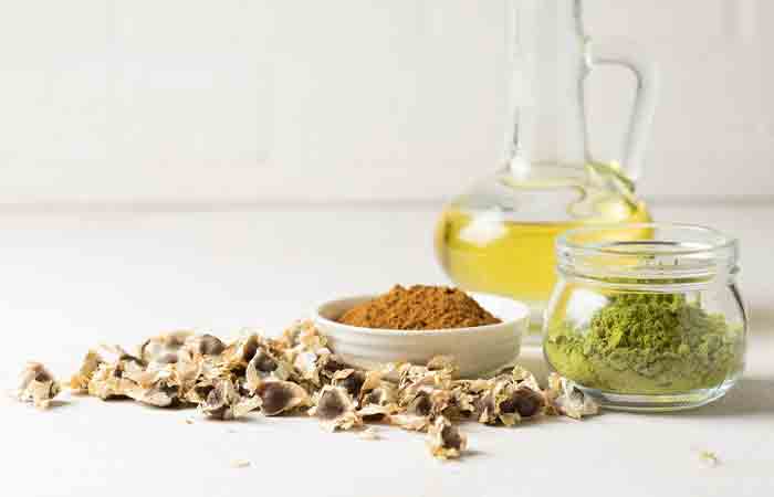 Moringa powder and oil in a glass bottle