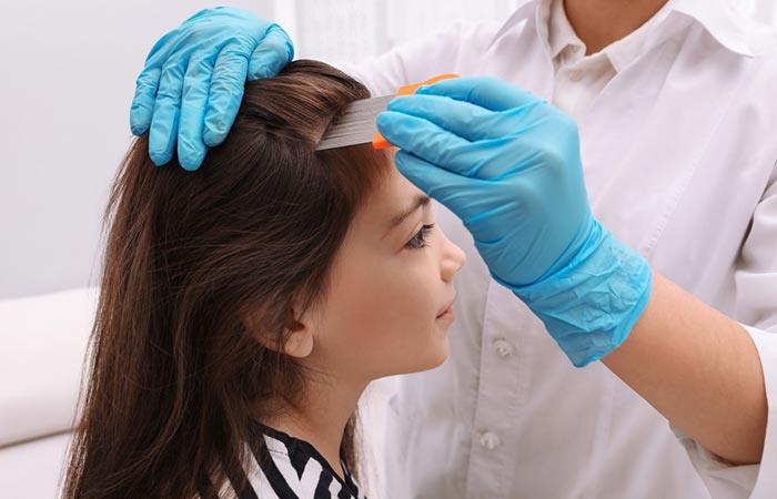 A woman removing the lice and nits