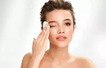 Woman removing her eye makeup to protect her sensitive eyes