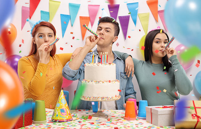 Teenage boy celebrating his birthday with sisters