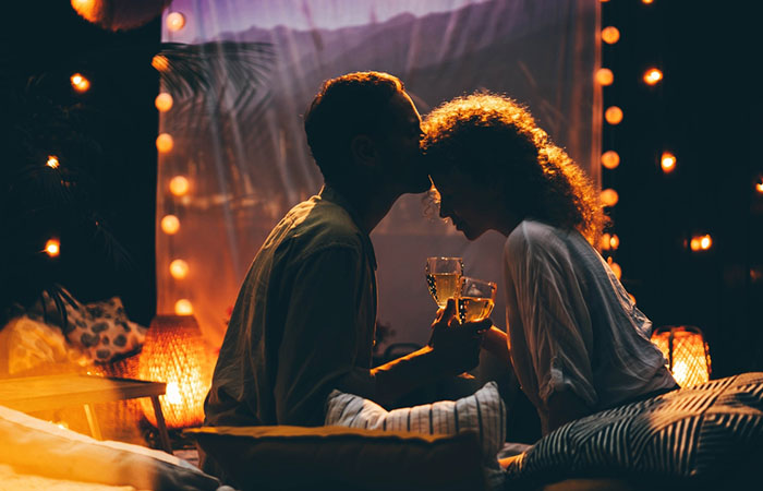 Couple enjoying movie night with wine