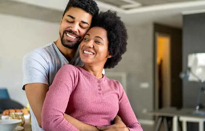 Cute couple in a back-hug embrace.