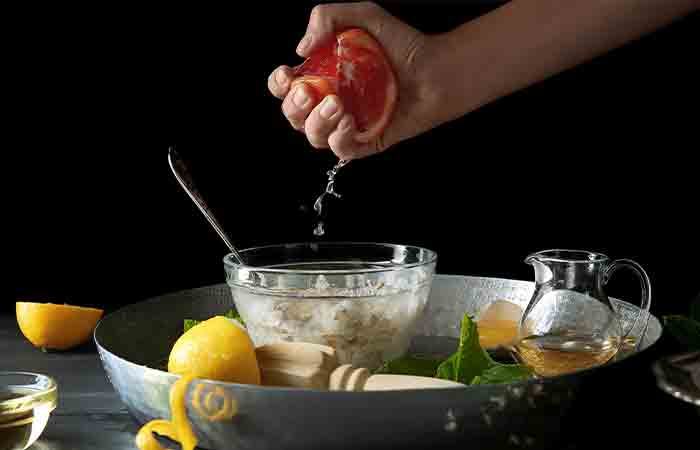 Hand juicing grapefruit to mix with egg whites
