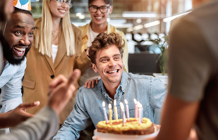 Man laughing and celebrating his birthday with his friends