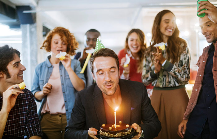 Man celebrating his birthday with his friends and family
