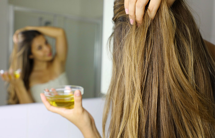 Woman using soy bean oil for hair growth.
