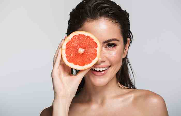 Woman with hydrated skin holding grapefruit
